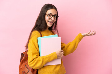 Naklejka premium Young student woman over isolated background extending hands to the side for inviting to come