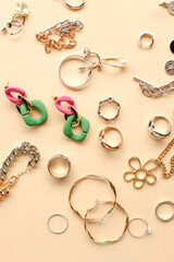 golden and silver jewelry on beige background. top view. hair jewelry, accessories, earrings, necklace, bracelet