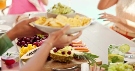Hands, friends and summer party with lunch on patio for vacation, bonding and reunion. Group of people, sharing and new years celebration with holiday and outdoors for fruits, nutrition or brunch