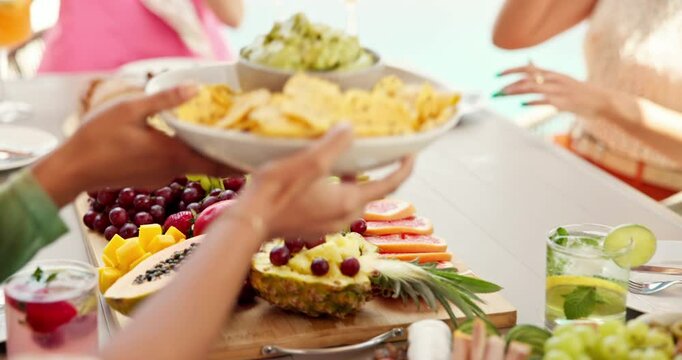 Hands, friends and summer party with lunch on patio for vacation, bonding and reunion. Group of people, sharing and new years celebration with holiday and outdoors for fruits, nutrition or brunch