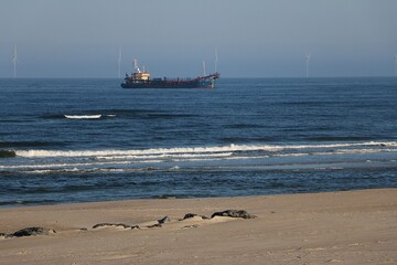 tanker lies at anchor off the coast in beautiful weather with blue sky