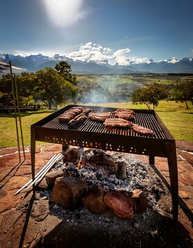 Generated image Argentinian asado grill filled with an assortment of meats, embers glowing parilla