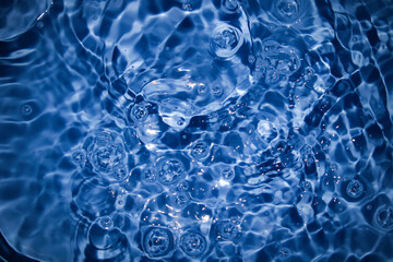 Close-up of rippling water reflecting sunlight, creating mesmerizing patterns and textures.