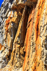 The rock is brown and has a lot of rust on it