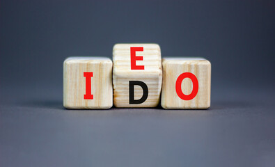Initial exchange or DEX offering symbol. Concept words abbreviation IEO or IDO on wooden block....