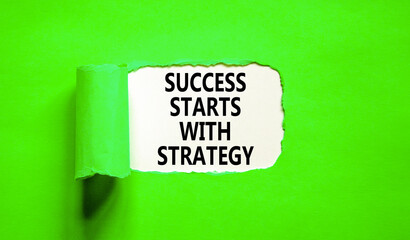 Success starts with strategy symbol. Concept words Success starts with strategy on beautiful white paper. Beautiful green background. Business and success starts with strategy concept. Copy space.