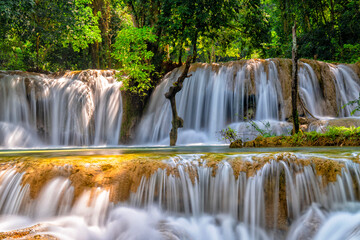 Fototapeta premium Waterfall Kuang Si. Luang Prabang, Laos. Travel and tourism in Asia. Beautiful and largest park with cascades of waterfalls in Laos