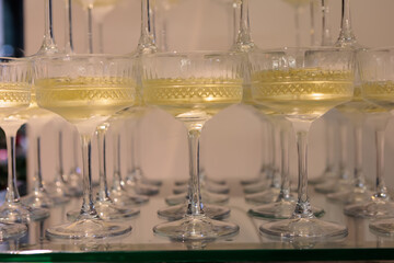 Towering pyramid of champagne glasses filled with bubbly