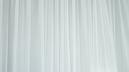 Obraz premium Transparent blurred white silk soft fabrics floating with sunlight shining through, shadows reflected on the textile surface.