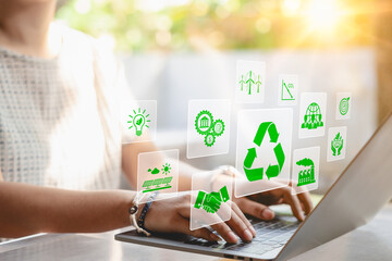 Sustainable development planning concept. A woman using a laptop with virtual icons related to...
