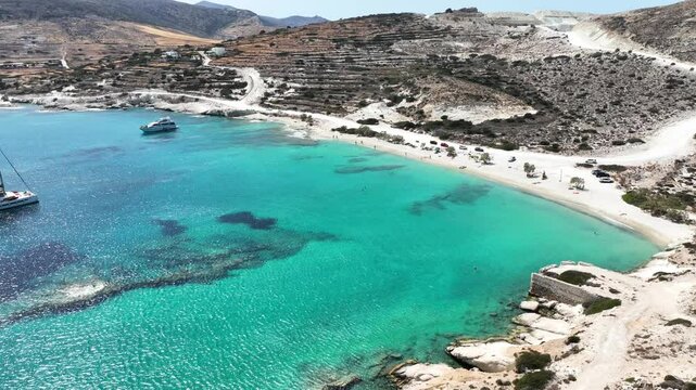 Aerial drone cinematic video of white sandy paradise beach of Prassa with turquoise crystal clear sea voted one of the best in Greece, Kimolos island, Cyclades