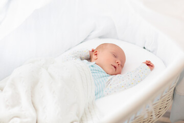 Cute newborn baby in white bed