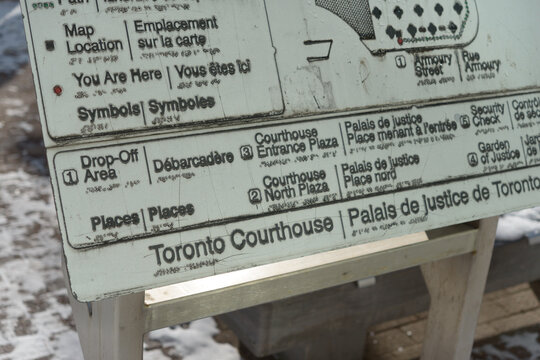 detailed metallic sign outside the 361 University Avenue Courthouse in Toronto, Canada
