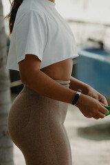 Young female in activewear holding expander