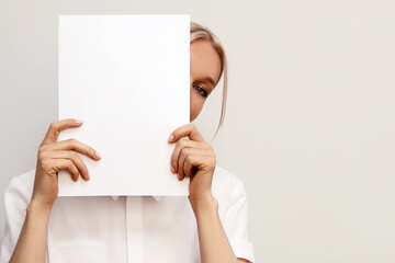 young beautiful woman with paper for printing texts on light backgroun, concept of business lady,...