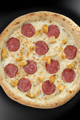details of the pizza application; juicy pizza from the oven with mushrooms, tomatoes and bacon and sprinkled with parmesan cheese
