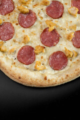 details of the pizza application; juicy pizza from the oven with mushrooms, tomatoes and bacon and sprinkled with parmesan cheese