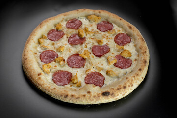 details of the pizza application; juicy pizza from the oven with mushrooms, tomatoes and bacon and sprinkled with parmesan cheese
