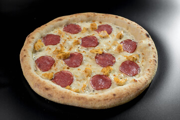 details of the pizza application; juicy pizza from the oven with mushrooms, tomatoes and bacon and sprinkled with parmesan cheese