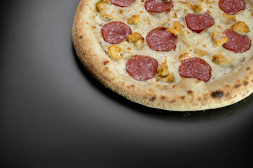 details of the pizza application; juicy pizza from the oven with mushrooms, tomatoes and bacon and sprinkled with parmesan cheese