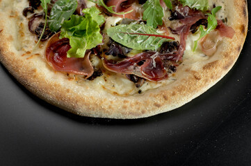 details of the pizza application; juicy pizza from the oven with mushrooms, tomatoes and bacon and sprinkled with parmesan cheese