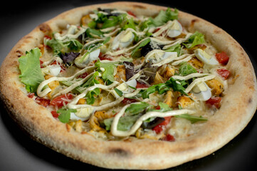details of the pizza application; juicy pizza from the oven with mushrooms, tomatoes and bacon and sprinkled with parmesan cheese