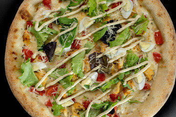 details of the pizza application; juicy pizza from the oven with mushrooms, tomatoes and bacon and sprinkled with parmesan cheese