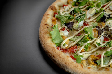 details of the pizza application; juicy pizza from the oven with mushrooms, tomatoes and bacon and sprinkled with parmesan cheese