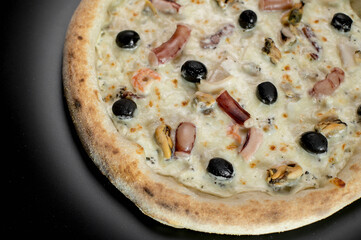 details of the pizza application; juicy pizza from the oven with mushrooms, tomatoes and bacon and sprinkled with parmesan cheese