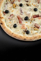 details of the pizza application; juicy pizza from the oven with mushrooms, tomatoes and bacon and sprinkled with parmesan cheese