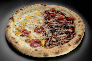 details of the pizza application; juicy pizza from the oven with mushrooms, tomatoes and bacon and sprinkled with parmesan cheese