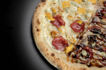 details of the pizza application; juicy pizza from the oven with mushrooms, tomatoes and bacon and sprinkled with parmesan cheese