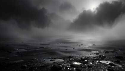 A low-angle view of a misty landscape featuring a wet, sandy surface scattered with small stones. The scene is shrouded in fog, with dark, ominous clouds overhead and a diffused light breaking throug.