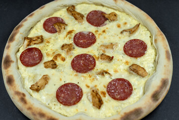 details of the pizza application; juicy pizza from the oven with mushrooms, tomatoes and bacon and sprinkled with parmesan cheese