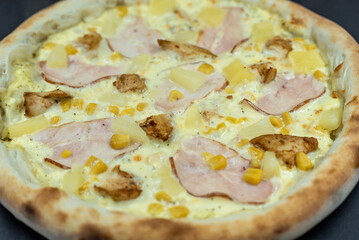 details of the pizza application; juicy pizza from the oven with mushrooms, tomatoes and bacon and sprinkled with parmesan cheese