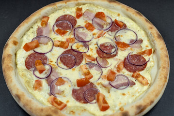 details of the pizza application; juicy pizza from the oven with mushrooms, tomatoes and bacon and sprinkled with parmesan cheese