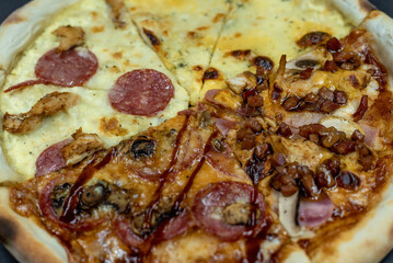 details of the pizza application; juicy pizza from the oven with mushrooms, tomatoes and bacon and sprinkled with parmesan cheese