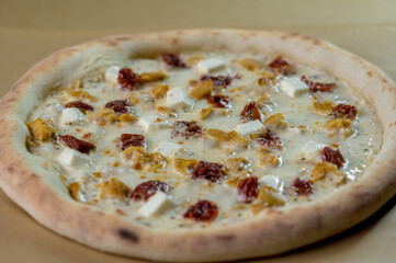 details of the pizza application; juicy pizza from the oven with mushrooms, tomatoes and bacon and sprinkled with parmesan cheese