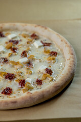 details of the pizza application; juicy pizza from the oven with mushrooms, tomatoes and bacon and sprinkled with parmesan cheese