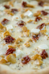 details of the pizza application; juicy pizza from the oven with mushrooms, tomatoes and bacon and sprinkled with parmesan cheese