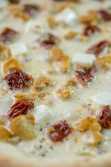 details of the pizza application; juicy pizza from the oven with mushrooms, tomatoes and bacon and sprinkled with parmesan cheese