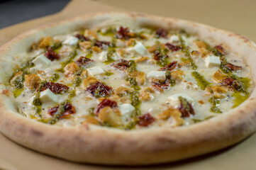 details of the pizza application; juicy pizza from the oven with mushrooms, tomatoes and bacon and sprinkled with parmesan cheese