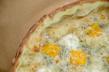 details of the pizza application; juicy pizza from the oven with mushrooms, tomatoes and bacon and sprinkled with parmesan cheese