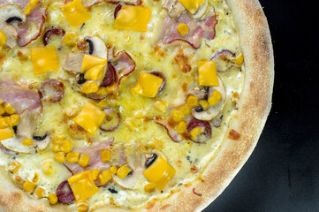 details of the pizza application; juicy pizza from the oven with mushrooms, tomatoes and bacon and sprinkled with parmesan cheese