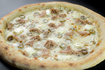 details of the pizza application; juicy pizza from the oven with mushrooms, tomatoes and bacon and sprinkled with parmesan cheese