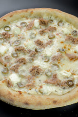 details of the pizza application; juicy pizza from the oven with mushrooms, tomatoes and bacon and sprinkled with parmesan cheese