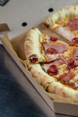 details of the pizza application; juicy pizza from the oven with mushrooms, tomatoes and bacon and sprinkled with parmesan cheese