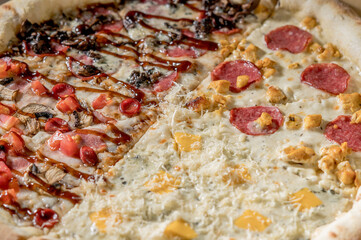 details of the pizza application; juicy pizza from the oven with mushrooms, tomatoes and bacon and sprinkled with parmesan cheese