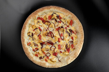 details of the pizza application; juicy pizza from the oven with mushrooms, tomatoes and bacon and sprinkled with parmesan cheese