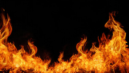 Fototapeta premium Bright fiery flames isolated against a deep black background 